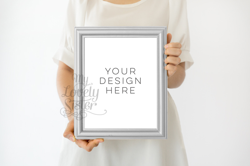 silver-frame-girl-holding-print-wall-art-mockup-minimalist-product-mockup-girl-holding-frame-photoshop-mock-up-styled-stock-photography